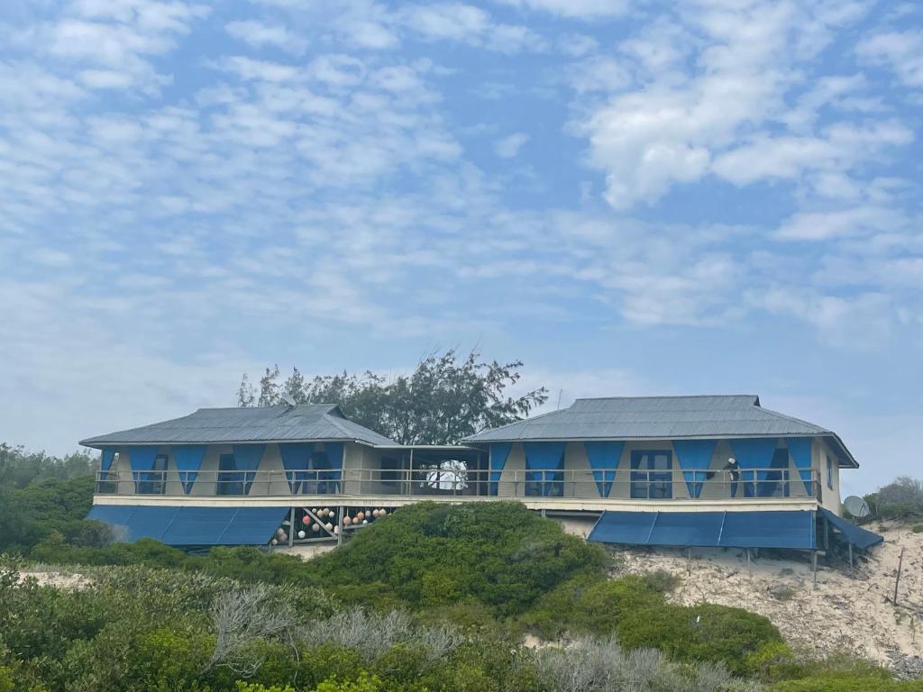 The lodge's elevated unit with its blue wraparound balcony on the dune